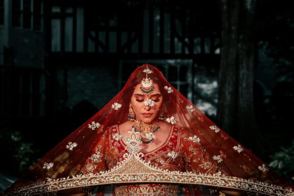 Pakistani bride wearing a red bridal dress showcasing different shades of red bridal lehengas for weddings in 2026